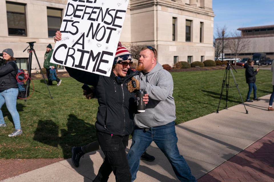 Emily Chaill, a supporter of Kyle Rittenhouse, reacts as a not guilt verdict is read while another man moves her away from an opposing crowd in front of the Kenosha County Courthouse on November 19, 2021 in Kenosha, Wisconsin (Getty Images)