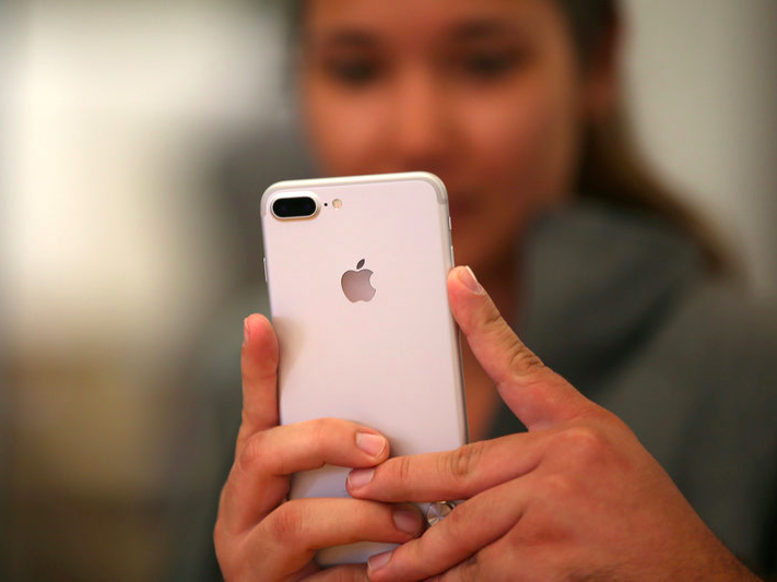 FILE PHOTO: A customer views the new iPhone 7 smartphone inside an Apple Inc. store in Los Angeles, California, U.S., September 16, 2016. REUTERS/Lucy Nicholson/File Photo