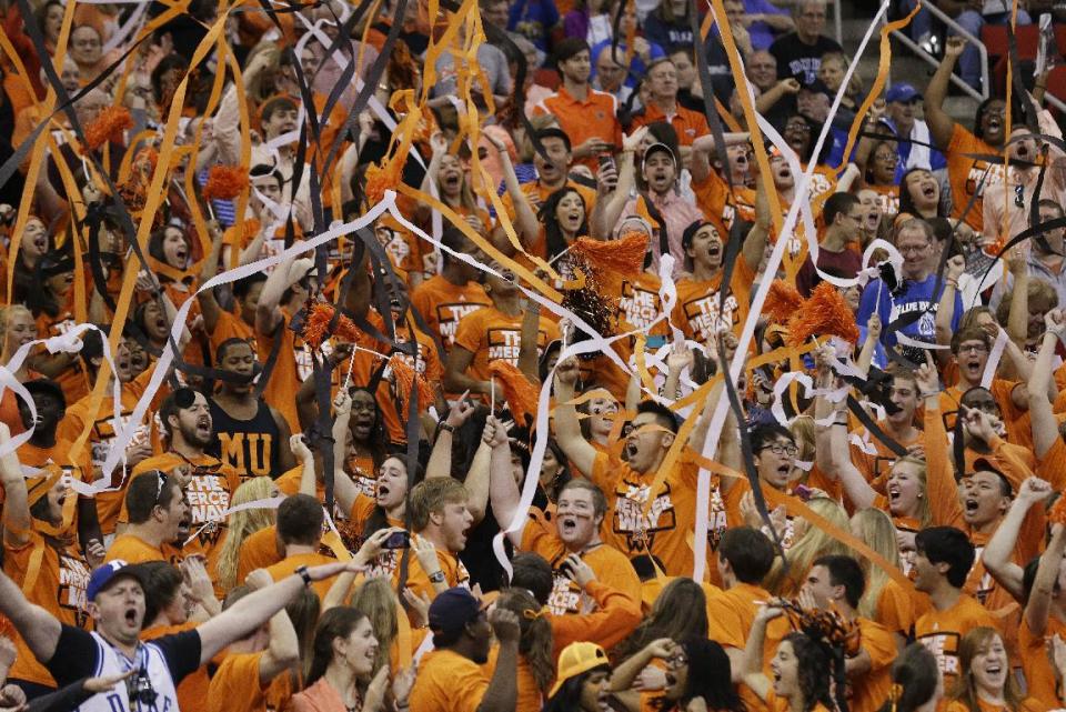 Mercer fans cheer during the first half of an NCAA college basketball second-round game against the Duke, Friday, March 21, 2014, in Raleigh, N.C. (AP Photo/Gerry Broome)