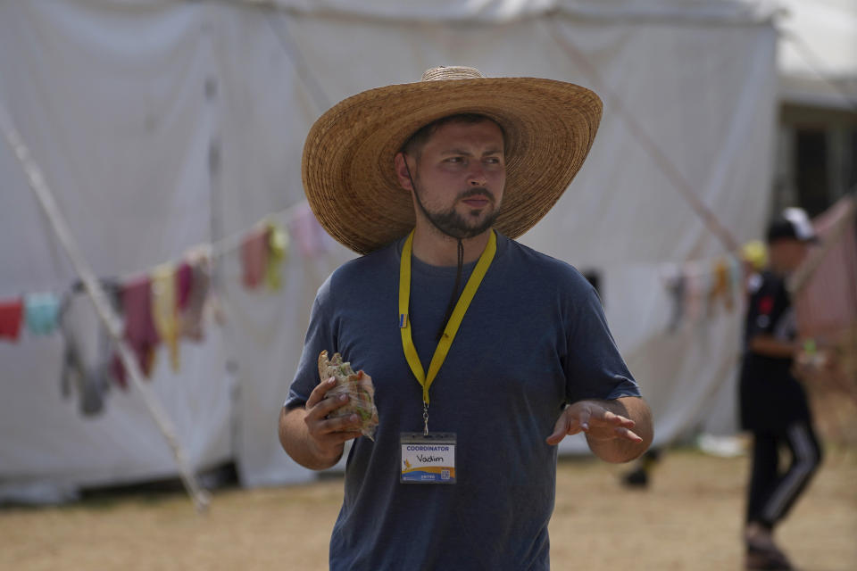 A Ukrainian known as Vadim, who works as a coordinator for arriving Ukrainian refugees gives an orientation talk at the camp in Utopia Park, Iztapalapa, Mexico City, Monday, May 2, 2022. (AP Photo/Marco Ugarte)