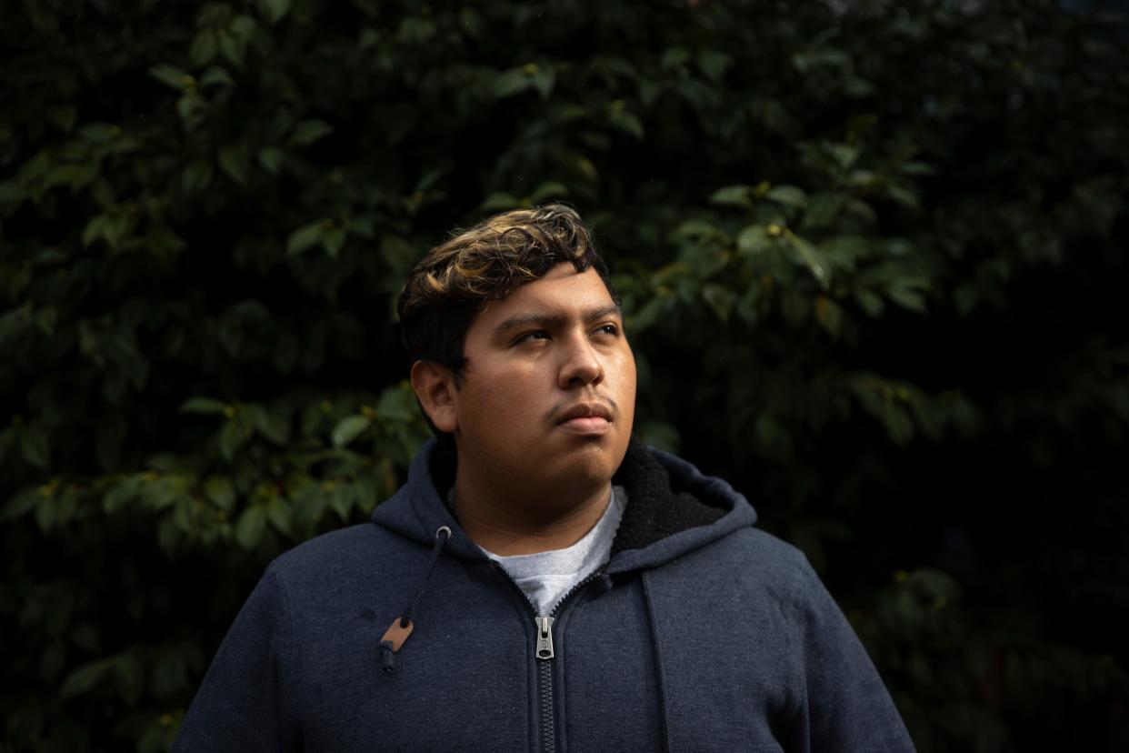 Julio Bryan Flores poses for a portrait at Oregon State University in Corvallis, Ore. on Thursday, Nov. 4, 2021. Flores and his family lost their home to the Almeda Fire in Phoenix, Ore. Their home was burned down on the same day Flores took his driver's test and his mother celebrated her birthday.