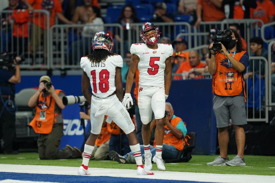 Dec 3, 2021; San Antonio, TX, USA; Western Kentucky Hilltoppers wide receiver Mitchell Tinsley (5) celebrates a touchdown catch with wide receiver Daewood Davis (18) during the first half of the 2021 Conference USA Championship Game against the UTSA Roadrunners at the Alamodome. Mandatory Credit: Daniel Dunn-USA TODAY Sports