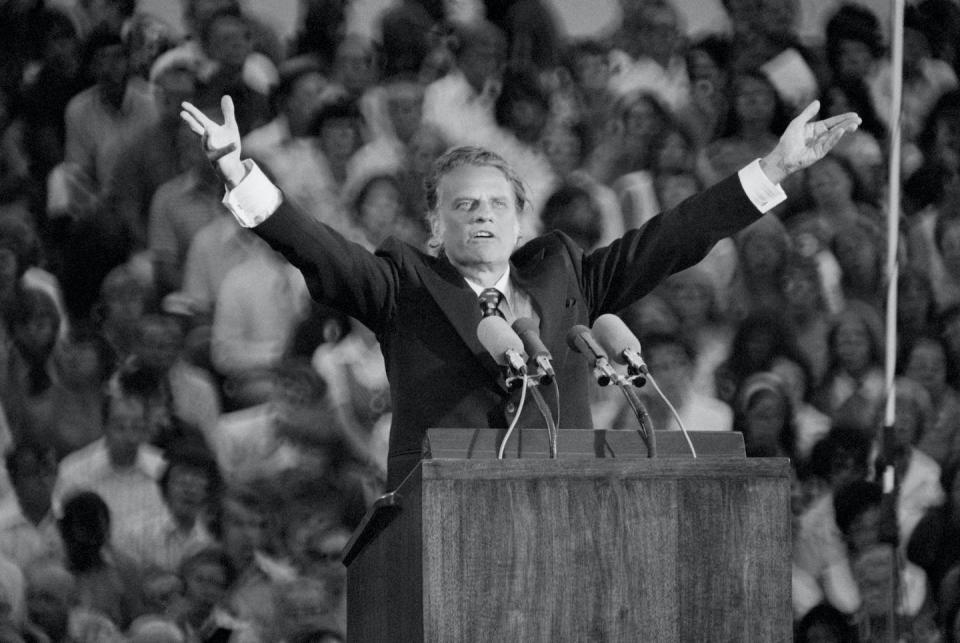 Evangelist Billy Graham reached millions who were attracted by his charisma and preaching style. <a href="https://www.gettyimages.co.uk/detail/news-photo/evangelist-billy-graham-preaches-to-a-crowd-of-21-000-in-st-news-photo/515575744?adppopup=true" rel="nofollow noopener" target="_blank" data-ylk="slk:Bettmann / Contributor via Getty Images;elm:context_link;itc:0;sec:content-canvas" class="link ">Bettmann / Contributor via Getty Images</a>