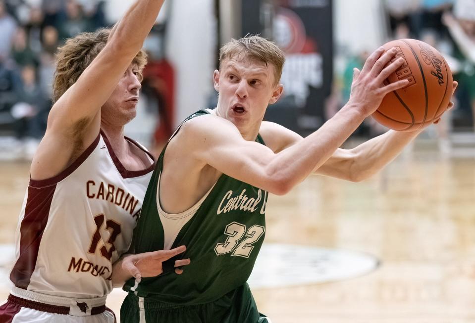 Central Catholic’s Luke Viacovsky is guarded by Cardinal Mooney’s Nick Pregibon during a regional semifinal, Wednesday, March 13, 2024, at the Field House.