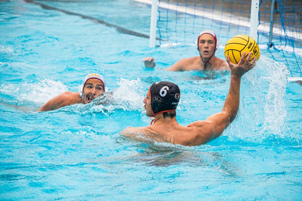 Stefan Vavic (rigtht) raises the ball as he fines an open teammate during the Water Polo game at the University of the Pacific in Stockton, CA. on Sat. April 12, 2024.