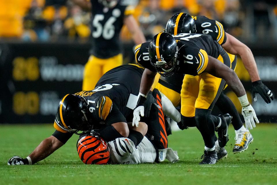 Bengals quarterback Jake Browning  is sacked by Pittsburgh Steelers defensive tackle Cameron Heyward  in the fourth quarter. Browning passed for 335 yards but was intercepted  three  times. He was also sacked three times for 26 yards.