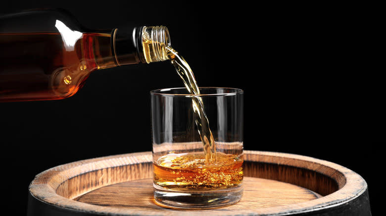 whiskey being poured into glass