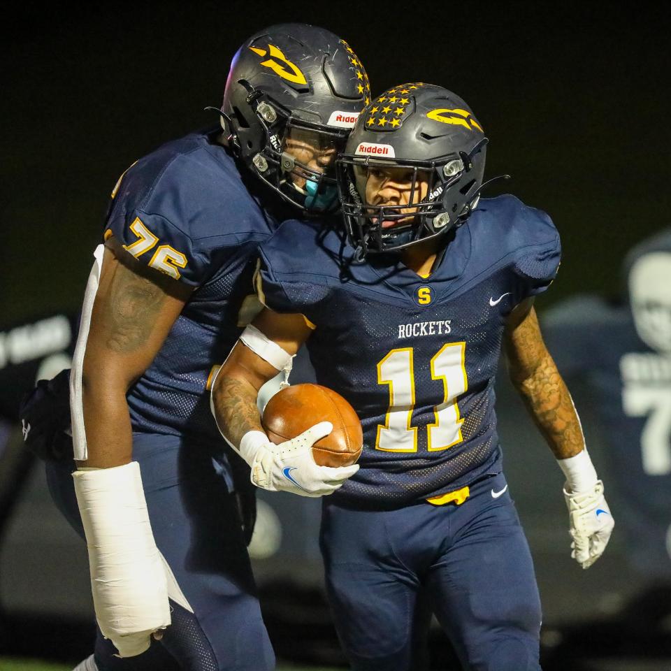 Streetsboro seniors Richtell McCallister and Michael Hall Jr. celebrate in the end zone after a rushing TD from McCallister during Friday night's Division III playoff game against the Niles McKinley Red Dragons at Streetsboro High School. [Nick McLaughlin, Special to The Record-Courier]