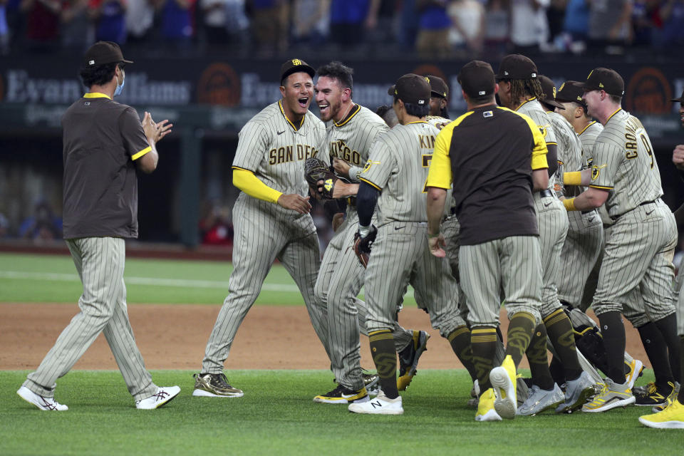 San Diego Padres starting pitcher Joe Musgrove (44) is mobbed by teammates after pitching a no-hitter against the Texas Rangers in a baseball game Friday, April 9, 2021, in Arlington, Texas. (AP Photo/Richard W. Rodriguez)