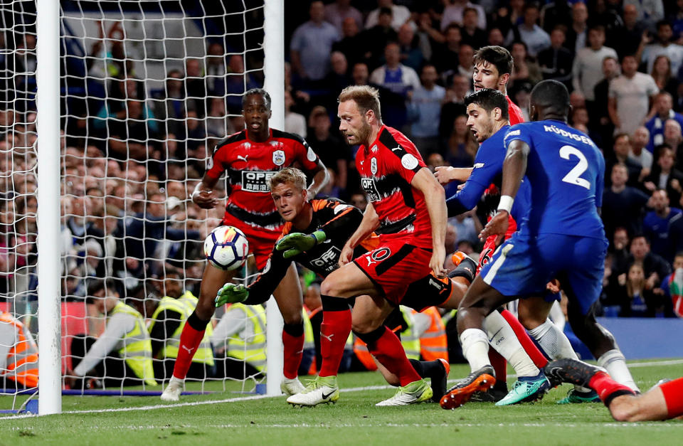 Huddersfield Town survived several frantic goalmouth scrambles to draw Chelsea and officially avoid Premier League relegation. (Reuters)