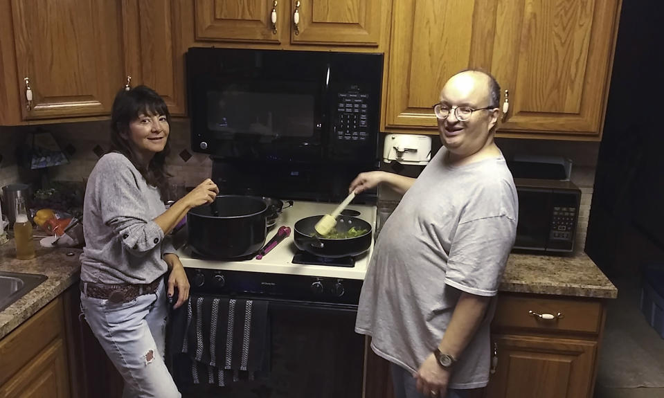 This 2020 photo provided by the family shows Anthony Talotta and his cousin's wife, Shelly Lagrotteria, cooking together during a visit in Pittsburgh. Talotta's family was working with attorneys to get the 57-year-old autistic man out of the Allegheny County Jail, where he had been taken on September 10, 2022 after a physical altercation with a staff member at the group home where he lived. But 11 days after he arrived at the jail, Talotta died from what his family says was a treatable and preventable infection from a wound he had received during the altercation at the group home. (Courtesy of Family via AP)