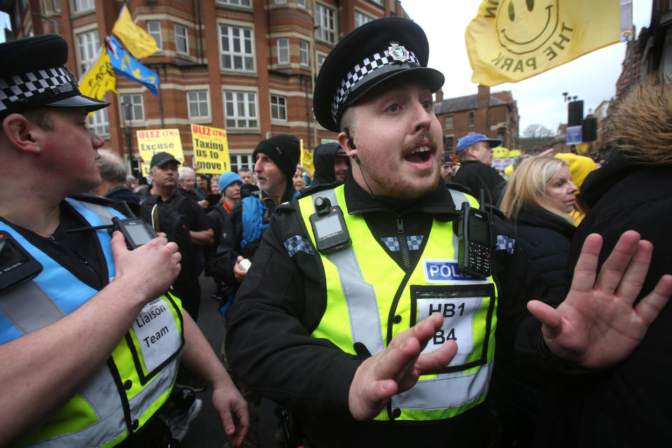 Police officers attempt to calm protesters in Oxford, England, Feb. 18
