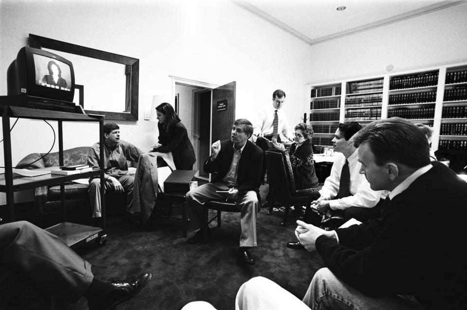 House Managers James Rogan and Lindsey Graham watch Monica Lewinsky on TV with Paul McNulty, Director of Legislative Operations for the House Majority Leader, and other staff in the Judiciary Committee Conference Room during the Senate Impeachment Trial of President Bill Clinton on Feb. 5, 1999 in Washington, DC. (Photo: David Hume Kennerly)/Getty Images)