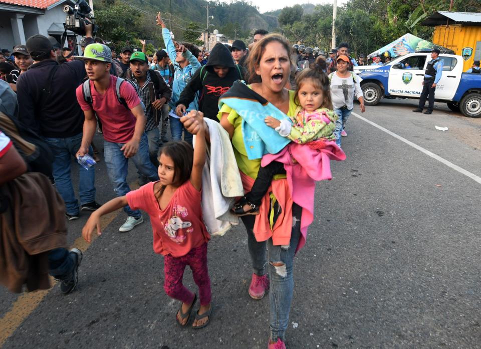 Honduran migrants heading to the United States break through a police line on the Honduras-Guatemala border in January 2019.