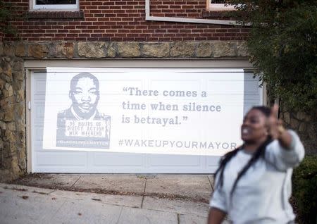 A black rights protester chants in front of a residence demonstrators identified as the home of Oakland Mayor Libby Schaaf in Oakland, California January 19, 2015. REUTERS/Noah Berger