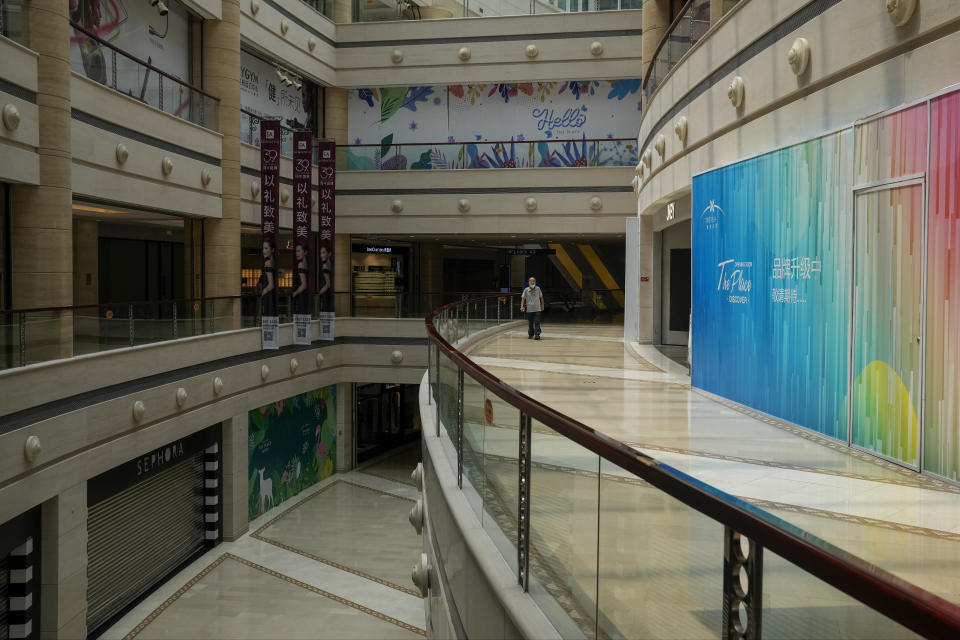 A man tour by a deserted shopping mall in Beijing on Thursday, July 27, 2023. Chinese leader Xi Jinping’s government is promising to drag the economy out of a crisis of confidence aggravated by tensions with Washington, wilting exports, job losses and anxiety among foreign companies about an expanded anti-spying law.(AP Photo/Andy Wong)