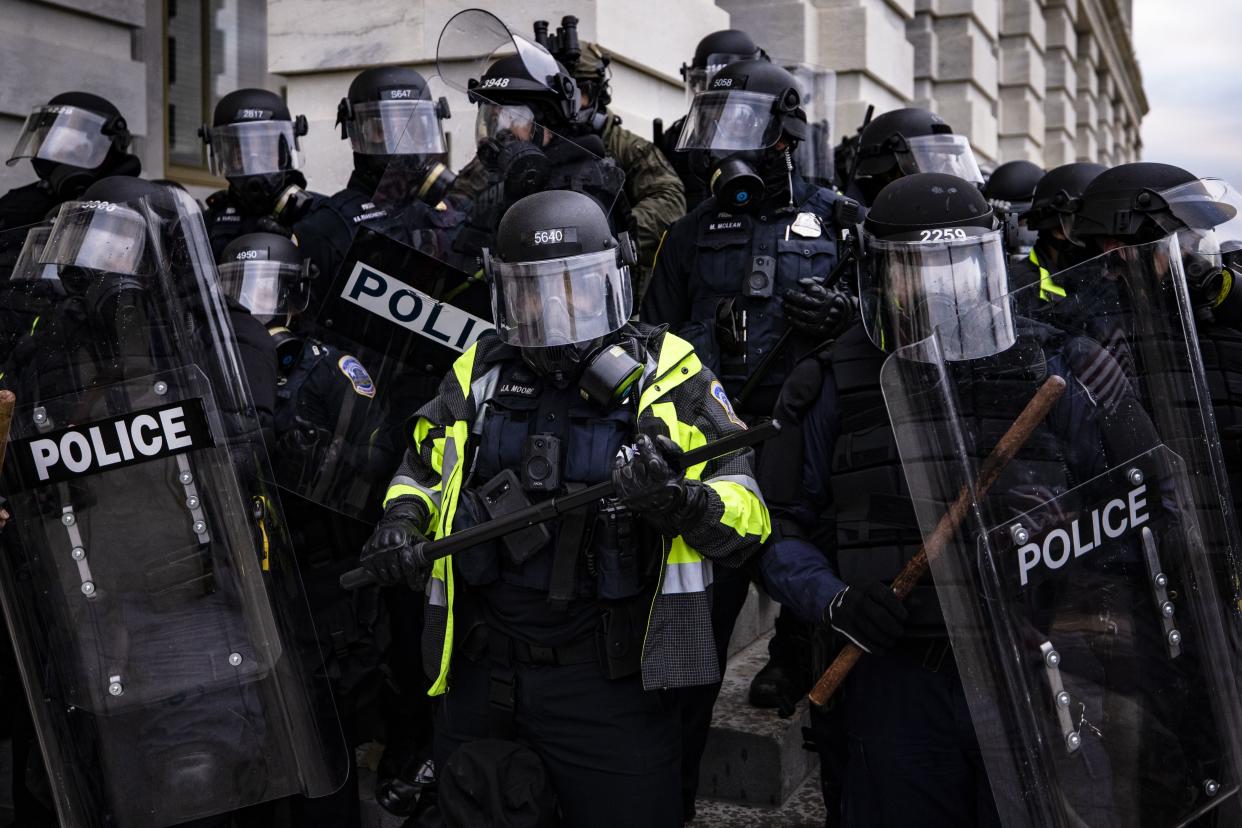 Police officers attempt to push back a pro-Trump mob trying to storm the U.S. Capitol following a rally with President Donald Trump on Jan. 6, in Washington, DC. 