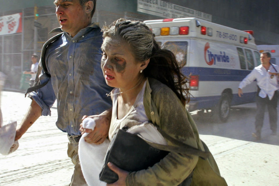 <p>People flee the scene near New York's World Trade Center Tuesday, Sept. 11, 2001. (AP Photo/Diane Bondareff)</p> 