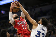Minnesota Timberwolves center Karl-Anthony Towns (32) and New Orleans Pelicans center Jonas Valanciunas (17) rebound in the first half of an NBA basketball game, Monday, Oct. 25, 2021, in Minneapolis. (AP Photo/Andy Clayton-King)