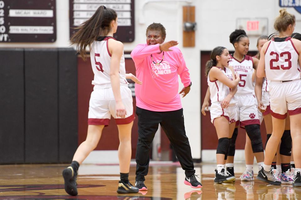 Wofford signee Evangelia Paulk (5) had a game-high 18 points in Asheville High's win over Reynolds on Tuesday. The senior's return to the Cougars after a year at Asheville Christian Academy has provided coach Sonita Warren-Dixon (center) a significant boost this season.