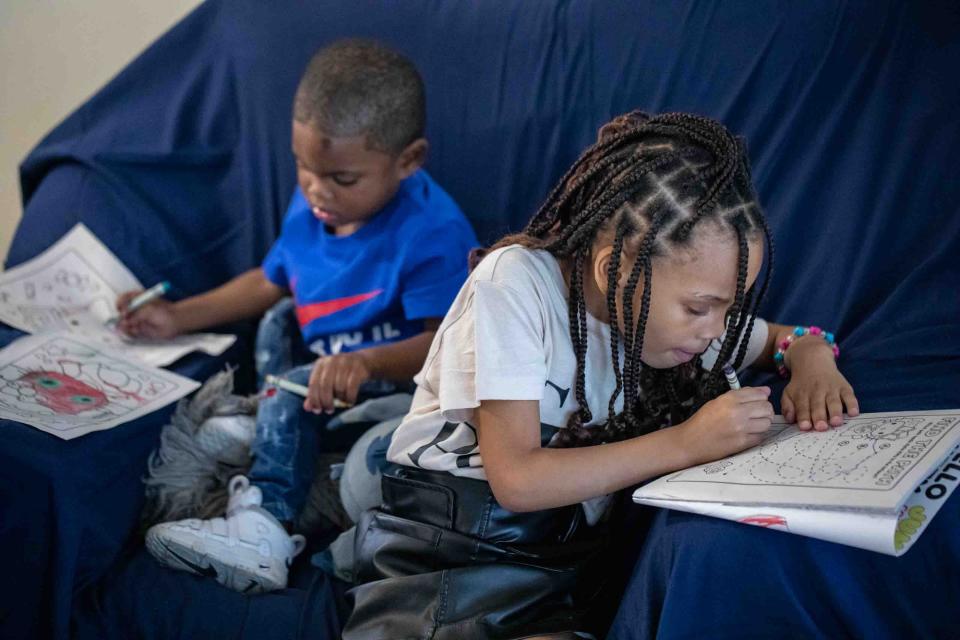 Tiffany Pinkney's children Kendric, 2, left, and Saniyah, 6, keep themselves busy and entertained in the family's Lake Worth Beach apartment.