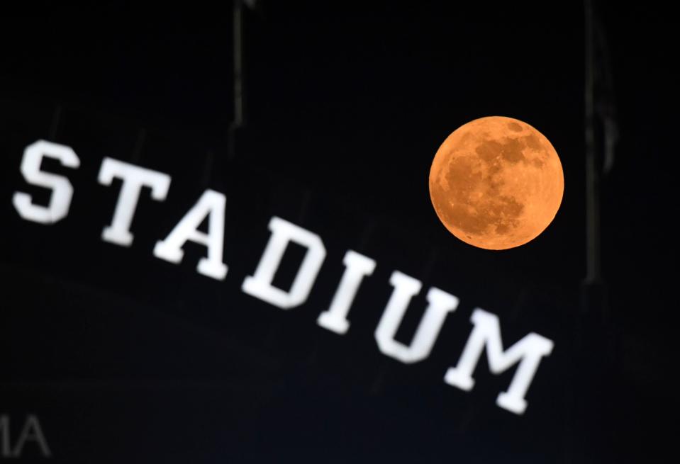 The Strawberry moon rises over the scoreboard at Sewell-Thomas Stadium in Tuscaloosa, Ala., Saturday June 4, 2023, during the winners bracket game of the NCAA Regional Baseball Tournament. 