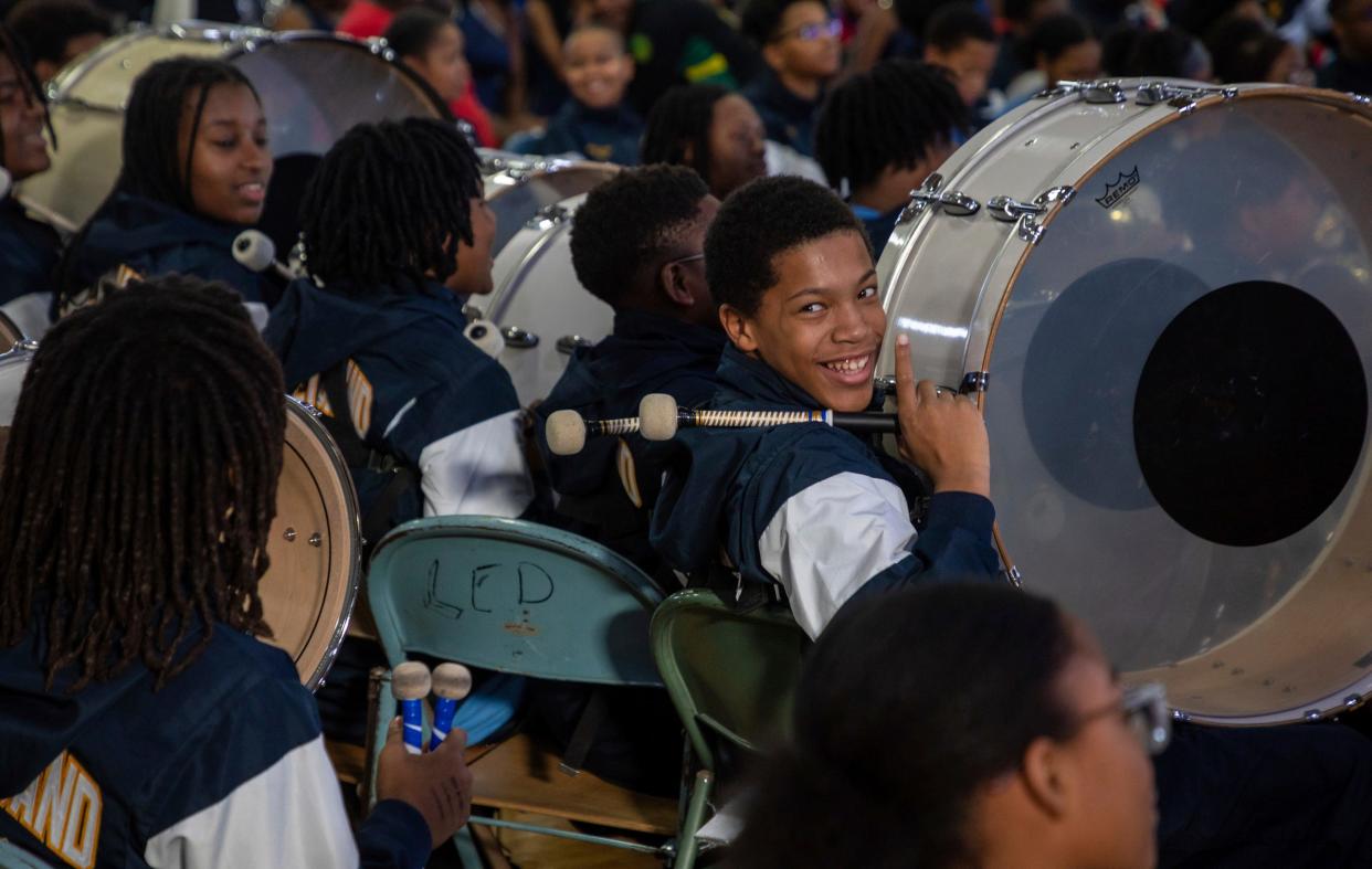 A Levey Middle School marching band member smiles as he prepares to perform in front of a large crowd during the 8th annual Harvest Festival inside the University High School Academy's gymnasium in Detroit on Wednesday, Nov. 22, 2023.