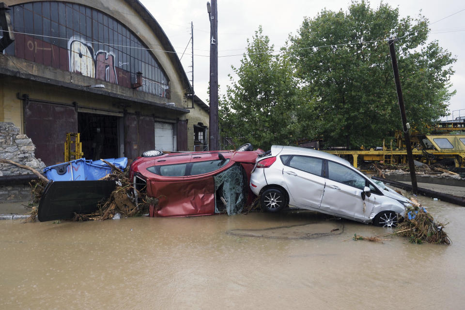 Damaged cars are pilled up on a flooded road after a rainstorm in Volos, central Greece, Wednesday, Sept. 6, 2023. The death toll from severe rainstorms that lashed parts of Greece, Turkey and Bulgaria increased Wednesday after rescue teams located the body of a missing vacation who was swept away by flood waters that raged through a campsite in northwest Turkey. (AP Photo/Thodoris Nikolaou)