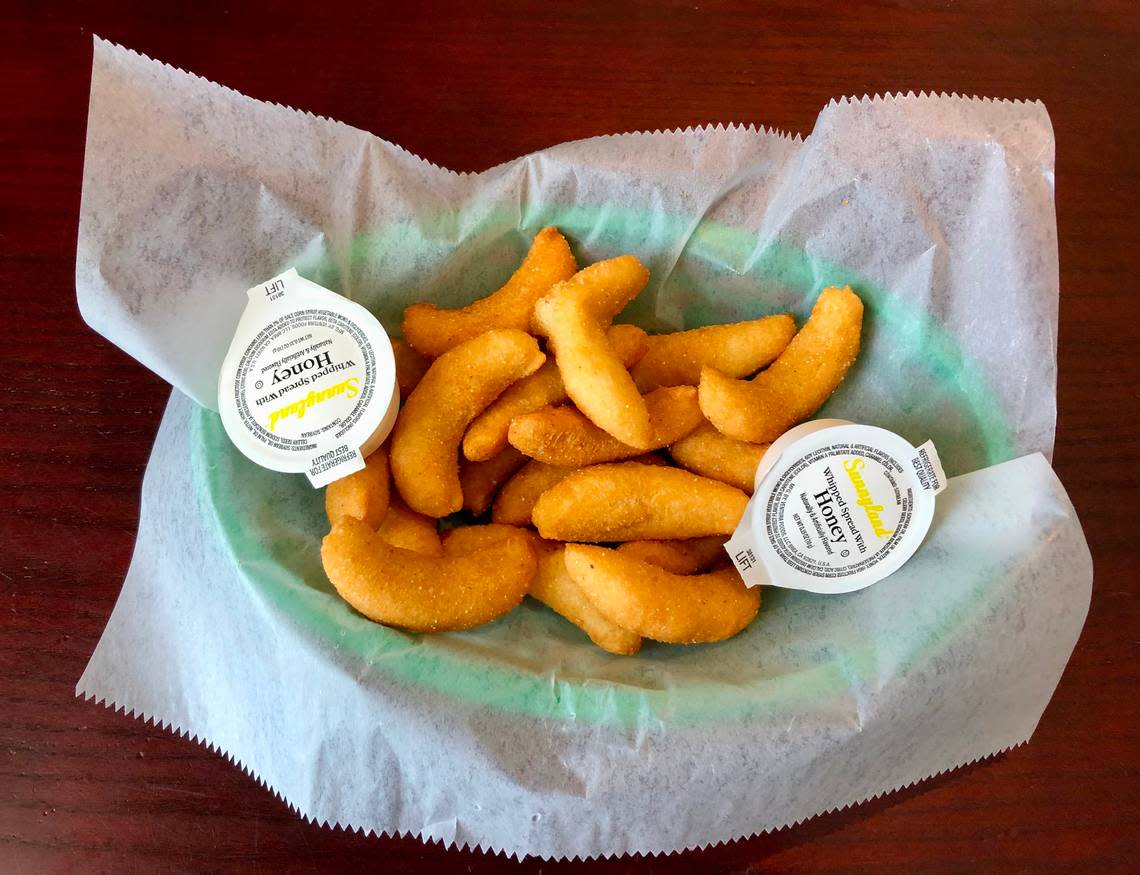Hushpuppies with honey butter at Beck’s Restaurant in Calabash, NC. Calabash-style fried fish can be found in North and South Carolina and beyond. August 2, 2023.