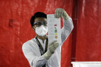 FILE - An official of the Union Election Commission counts ballots at a polling station in Yangon, Myanmar on Nov. 8, 2020. Ousted Myanmar leader Aung San Suu Kyi is the daughter of the country’s independence hero, Gen. Aung San, who was assassinated in 1947, less than six months before the country, then called Burma, became independent from Britain. Suu Kyi moved to New Delhi in 1960 when her mother was appointed ambassador to India and then spent most of her young adult life in the United States and England. Her career in politics began in 1988. (AP Photo/Thein Zaw, File)