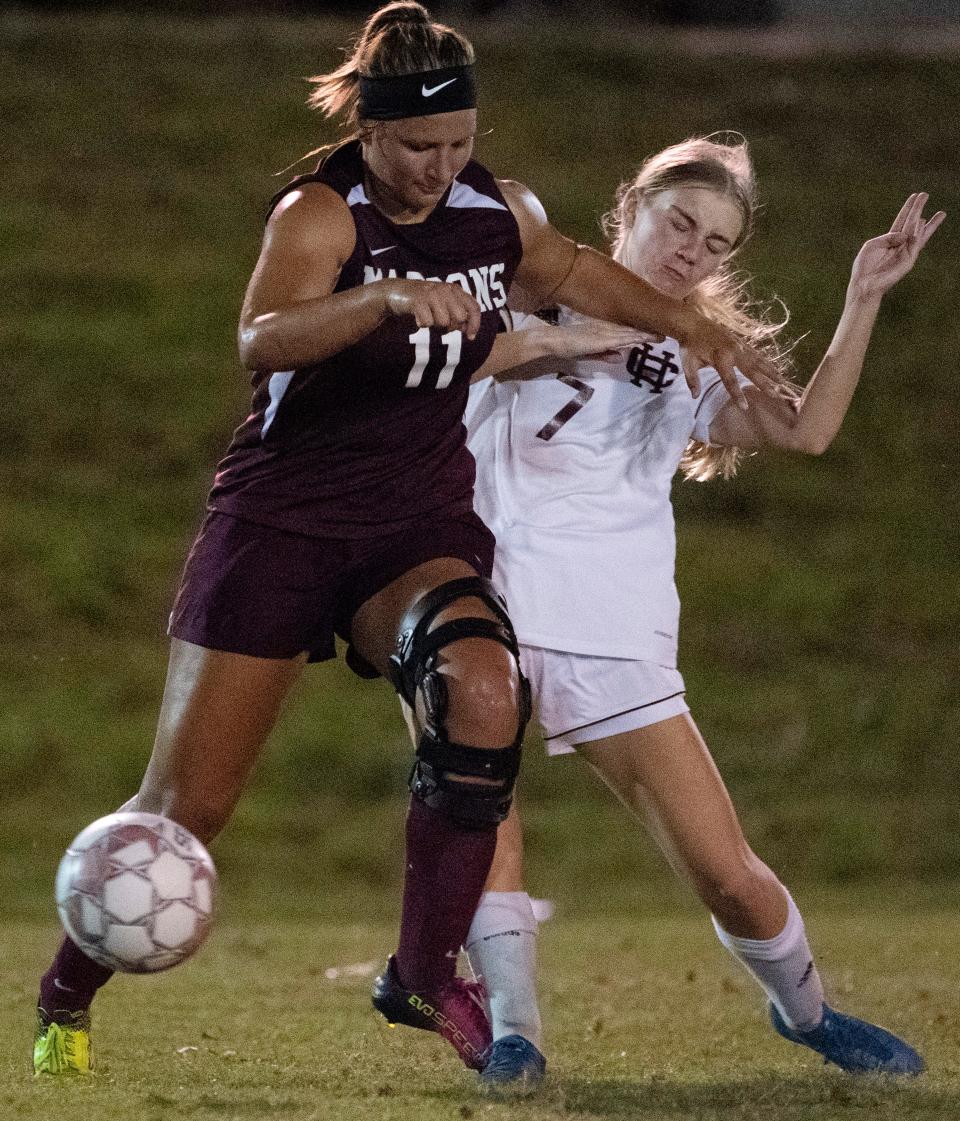 Madisonville's Camryn LaGrange (11) and Henderson's Ilana Hall (7) jostle for position during the finals of the Second Region Tournament at Donley Field at Madisonville-North Hopkins High School Thursday night, Oct. 14, 2021. Henderson County won the championship 6-4.