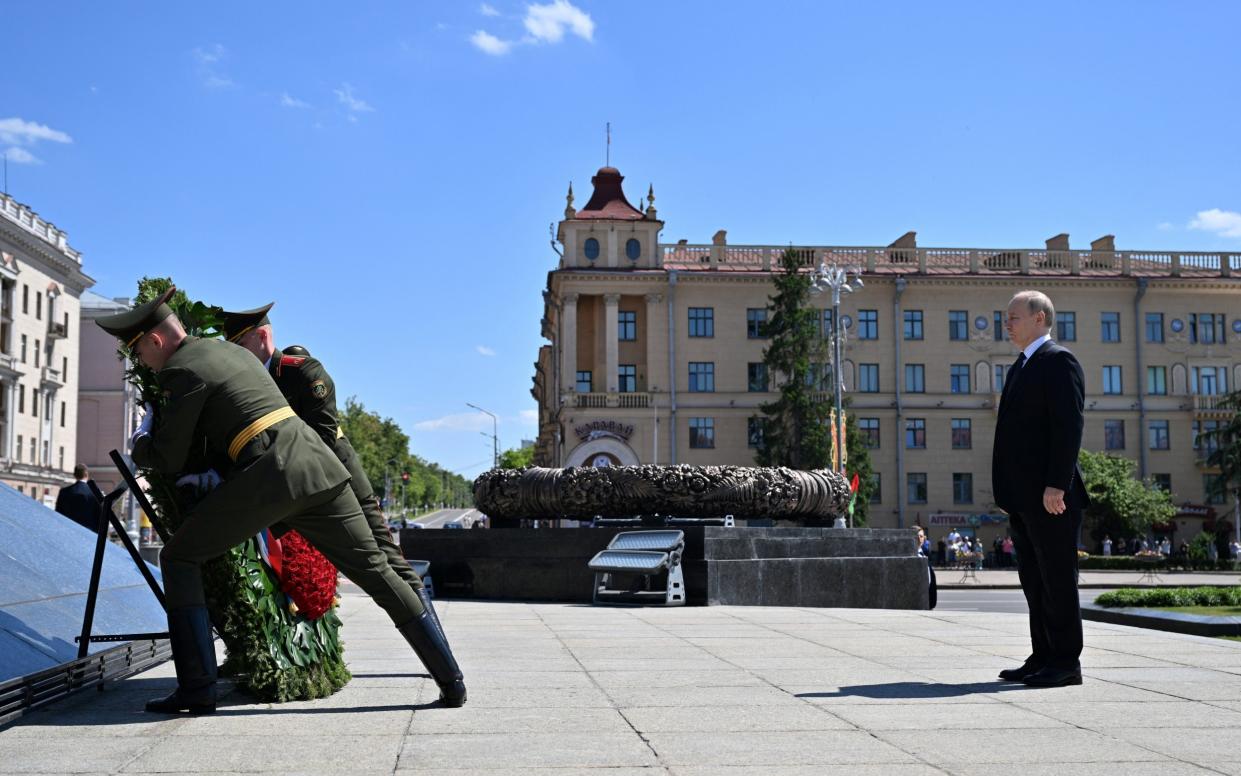 Russian President Vladimir Putin takes part in a wreath-laying ceremony at Victory Monument in Minsk