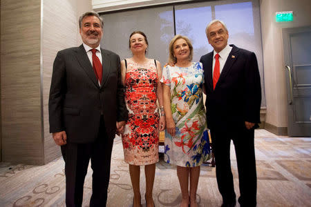 Chilean presidential candidate Sebastian Pinera and his wife Cecilia Morel stand with presidential candidate Alejandro Guillier and his wife Cristina Farga as they pose for a picture after Chile's presidential elections in Santiago, Chile, December 17, 2017. Jose Francisco Zuniga/Courtesy of presidential candidate Alejandro Guillier/Handout via Reuters. ATTENTION EDITORS - THIS IMAGE WAS PROVIDED BY A THIRD PARTY.