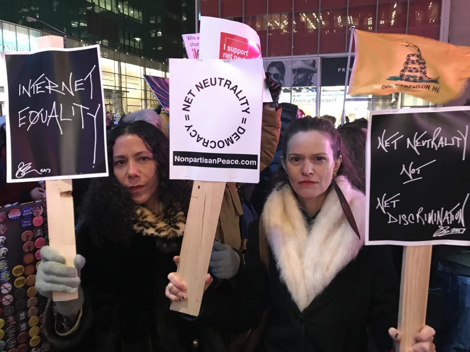 Net neutrality supporters Jennifer Elster (right) and friend gather at a rally in front of a Verizon store on 42nd Street in New York City on Dec. 7. (Photo: Jenna Amatulli)