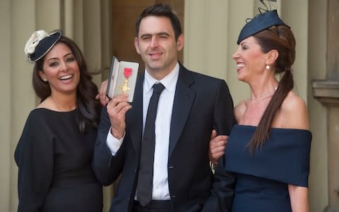 Ronnie O'Sullivan receiving an O.B.E. in 2016 pictured with his mother Maria O'Sullivan (right) and partner Laila Rouass (left) - Credit: JULIAN SIMMONDS