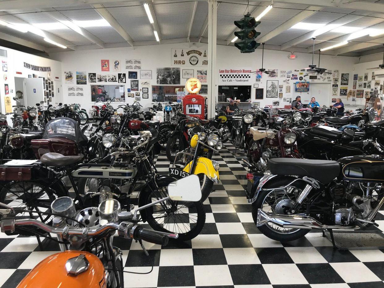 Lone Star Motorcycle Museum, Vanderpool, Texas, interior motorcycle showcase room with motorcycle signs on the walls