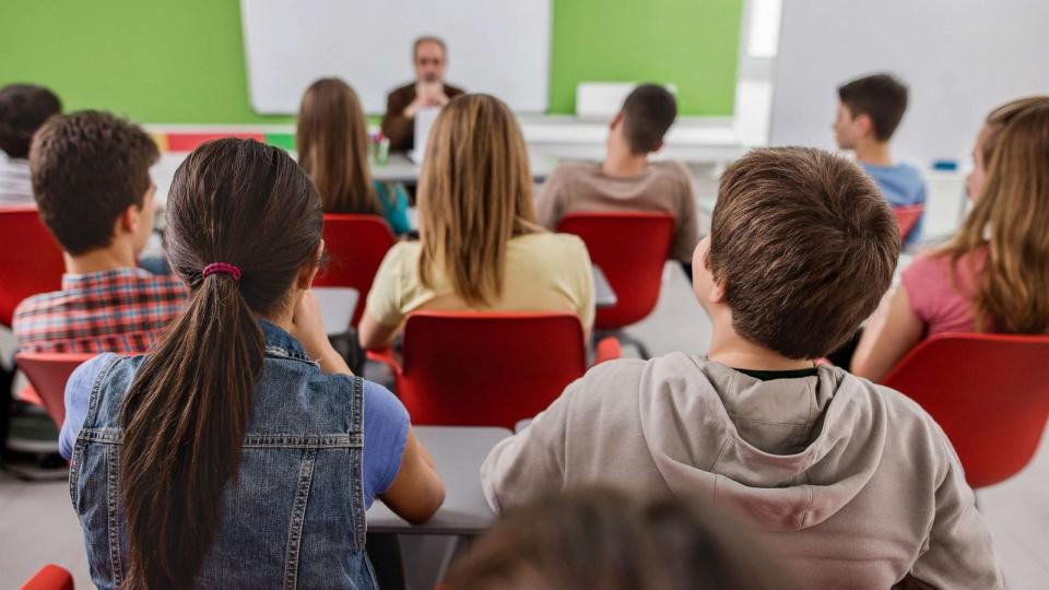 PHOTO: Back view of large group of students sitting in the classroom and listening to their teacher. (STOCK IMAGE/Getty Images)
