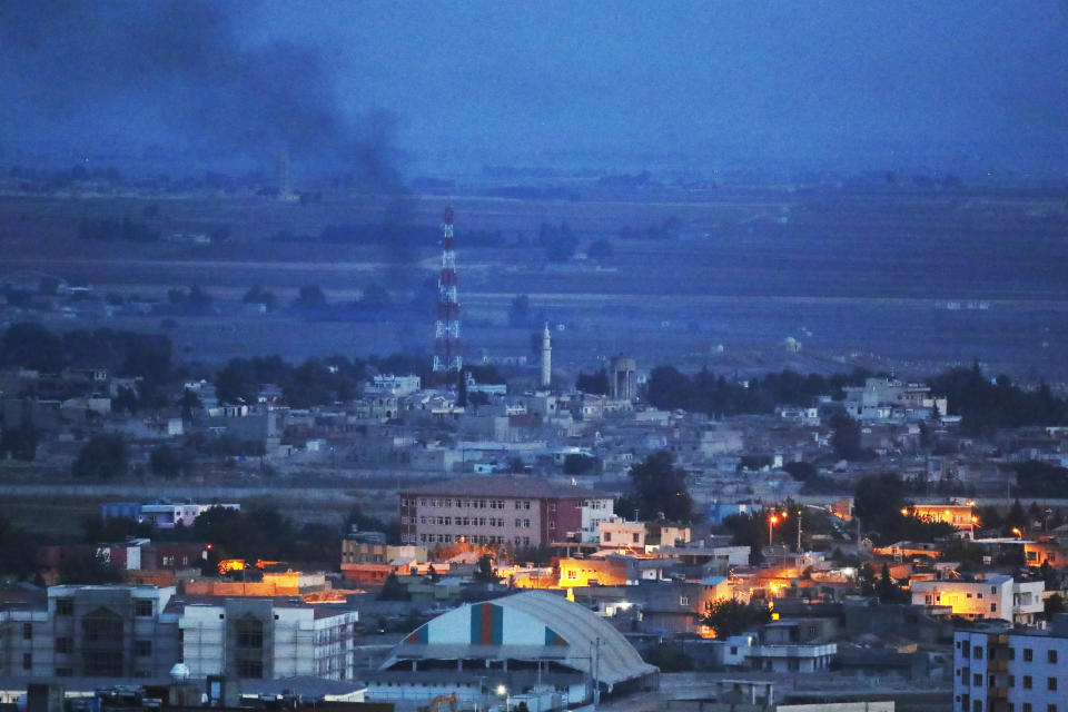 In this photo taken from the Turkish side of the border between Turkey and Syria, in Ceylanpinar, Sanliurfa province, southeastern Turkey, smoke billows from targets in Ras al-Ayn, Syria, caused by bombardment by Turkish forces, Tuesday, Oct. 15, 2019. Turkish artillery on Tuesday pounded suspected Syrian Kurdish positions near the town in northeast Syria amid reports that Kurdish fighters had retaken the town as Turkey pressed ahead with a military incursion that has drawn widespread condemnation. (AP Photo/Lefteris Pitarakis)