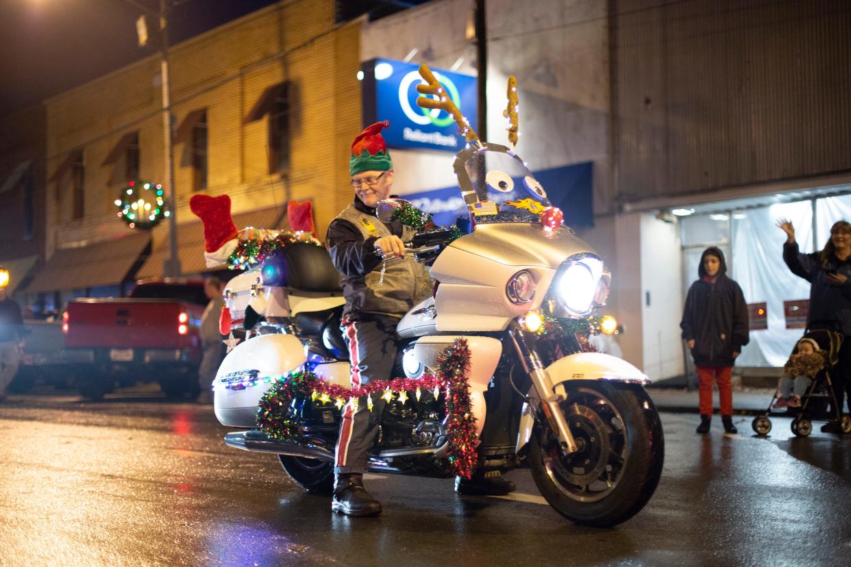 A motorcycle rider takes part in the Mt. Pleasant Rotary Christmas Parade on Saturday, Dec. 1, 2018.