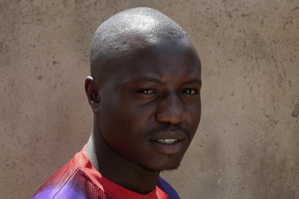 Tinashe Mapuranga poses outside his home near Harare, Zimbabwe, on Thursday, Aug, 25, 2021. Amid the lockdowns from the coronavirus pandemic, the 24-year-old was one of the first to be laid off from his job as an intern at a leading bank and has no idea when he'll be able to get his degree because of frequent school closures. "It has really affected me a lot in my studies. I have no money to buy data and I don't have a personal laptop to study online and keep up like what others are doing," said Mapuranga. A survey of young people in 15 African countries found that many have lost jobs or have seen their education disrupted by the pandemic. (AP Photo/Tsvangirayi Mukwazhi)