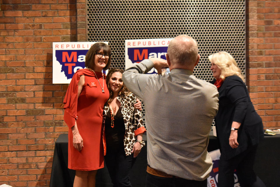 Montana U.S. House candidate Mary Todd, at left, poses with attendees at a dinner hosted by Butte-Silver Bow County Republicans at the Copper King Hotel and Convention Center, May 13, 2022, in Butte, Mont. Five GOP candidates are on the ballot for the June 7 Republican primary for the newly created House district in western Montana. (AP Photo/Matthew Brown)