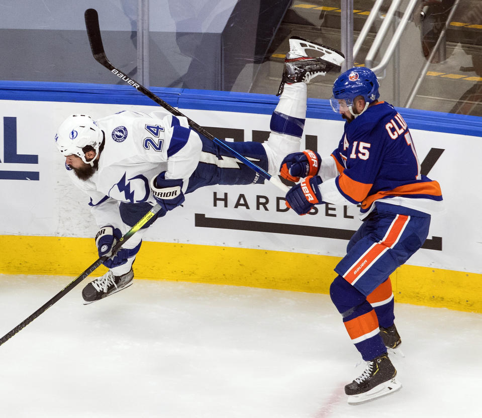 Tampa Bay Lightning defenseman Zach Bogosian (24) is checked by New York Islanders right wing Cal Clutterbuck (15) during the second period of Game 6 of the NHL hockey Eastern Conference final, Thursday, Sept. 17, 2020, in Edmonton, Alberta. (Jason Franson/The Canadian Press via AP)