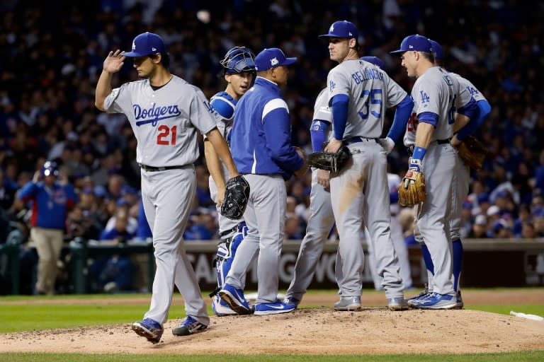 Manager Dave Roberts of the Los Angeles Dodgers relieves Yu Darvish (L) in the seventh inning against the Chicago Cubs during game three of the National League Championship Series, at Wrigley Field in Chicago, Illinois, on October 17, 2017