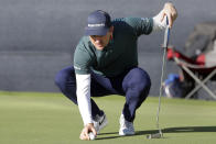 Justin Rose places his ball on the 18th green before putting during the third round of the Houston Open golf tournament, Saturday, Nov. 12, 2022, in Houston. (AP Photo/Michael Wyke)