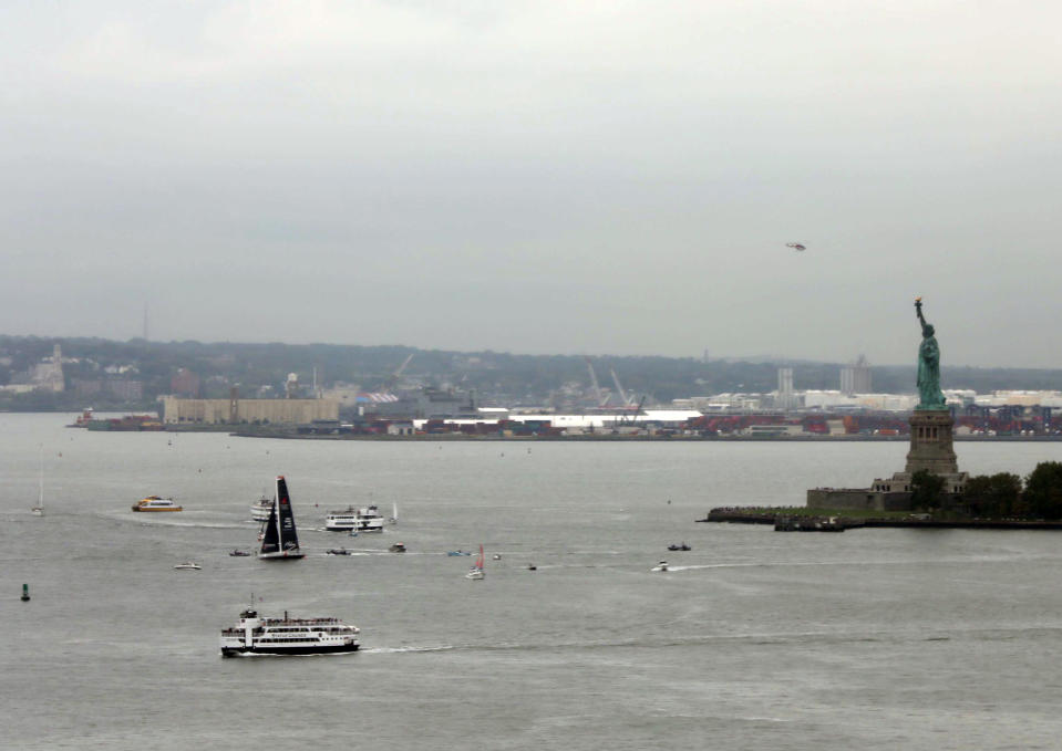 The Malizia II is surrounded by ferry boats and pleasure craft as it passes the Statue of Liberty with Swedish climate activist Greta Thunberg aboard at the conclusion of Thunberg's trans-Atlantic voyage, Wednesday, Aug. 28, 2019. The 16-year old Thunberg crossed the Atlantic aboard a zero-emissions sailboat to address the United Nations Climate Action Summit on Sept. 23. (AP Photo/Wong Maye-E)