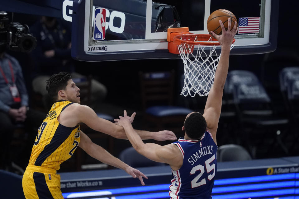 Philadelphia 76ers' Ben Simmons (25) dunks against Indiana Pacers' Doug McDermott (20) during the second half of an NBA basketball game, Tuesday, May 11, 2021, in Indianapolis. (AP Photo/Darron Cummings)