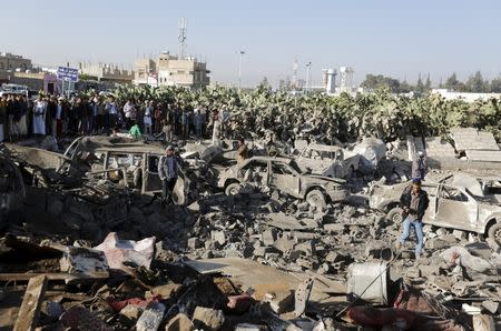 People gather at the site of an air strike at a residential area near Sanaa Airport March 26, 2015. REUTERS/Khaled Abdullah