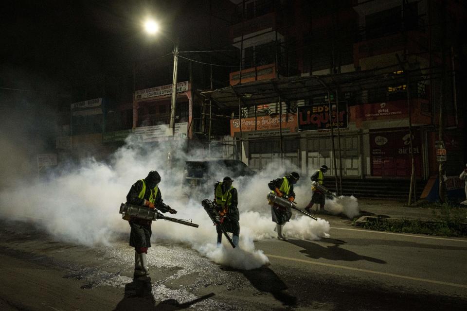 In Nairobi, Kenya, volunteers from Sonko Rescue Team, an NGO privately funded by Nairobi Governor Mike Sonko, fumigate a street on April 6 to curb the spread of COVID-19.