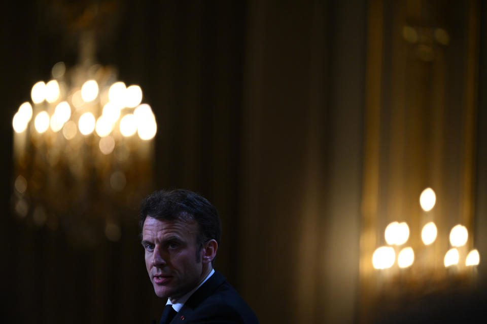 French President Emmanuel Macron looks over as he gives a speech ahead of his visit in Central Africa, at the Elysee Palace in Paris, Monday, Feb. 27, 2023. French President Emmanuel Macron unveiled his country's changing economic and military strategy in Africa for the coming years, as France's influence substantially declines on the continent. Macron begins an ambitious Africa trip on Wednesday to Gabon, Angola, the Republic of Congo and Congo.( Stefano Rellandini, Pool via AP)