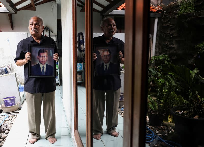Paian Siahaan, the 77-year-old father of Ucok Munandar Siahaan poses for a photograph after an interview at his house in Depok on the outskirts of Jakarta